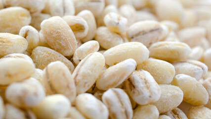 Pearl barley background close-up, top view. Pearl barley closeup, grain texture, top view. Pearl barley is processed barley grains that have been processed.