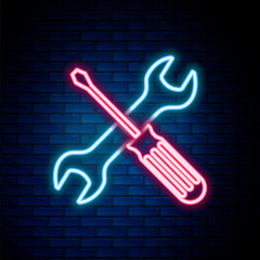 Glowing neon line Crossed screwdriver and wrench tools icon isolated on brick wall background. Service tool symbol. Colorful outline concept. Vector