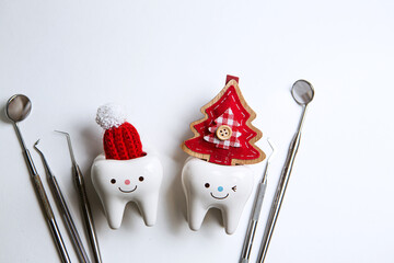new year dentistry. Christmas. dentist tools. figurines of teeth in a santa hat
