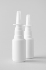 Nasal spray mockup. White plastic bottle with blank label.