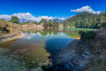 Deoria Tal , also Devaria or Deoriya is a high altitude lake in Uttarakhand, India. Blue sky with snow-covered mountains, Chaukhamba is one of them, in the background.