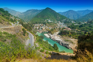 Fototapeta na wymiar Alaknanda and Bhagirathi rivers meet and take the name Ganga at Devprayag in the state of Uttarakhand, India, and is one of the Panch Prayag (five confluences). Hindu holy place.