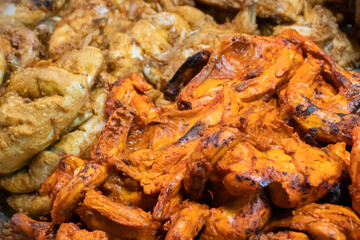 Spicy roasted tandoori butter chicken , prepared for sale at evening as street food in Old Delhi market. It is famous for spicy Indian non vegetarian street foods. It is famous tourist spot.