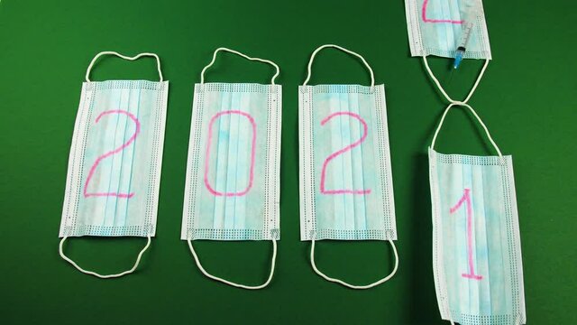 Medical masks with numbers written on them indicating the date of the new year. 2022 year change 2021 year. Another pandemic year concept.
