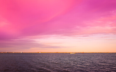 Pink clouds over Plymouth Harbor, Massachusetts. Vibrant seascape at twilight in New England, USA.