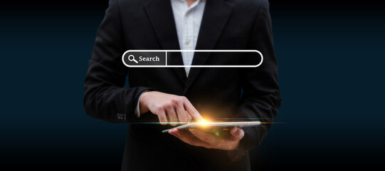 Searching. business man hand touching on digital mobile tablet with visual screen search button on dark background, browsing information, internet data technology and data search engine concept