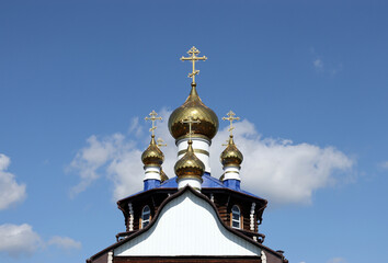 Fototapeta na wymiar Domes of the Temple in honor of All Saints in the Russian land who shone