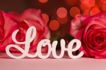 The word love in white letters on light background. Happy Valentine's Day, Mother's Day, March 8, World Women's Day concept