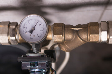 there is a pipe with water on the tiled wall. a water meter is also installed. automation is...