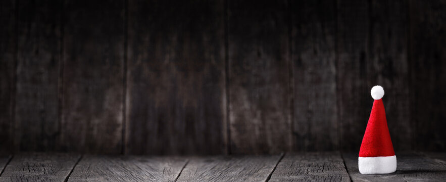Santa Claus hat on wooden rustic background