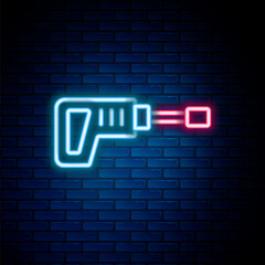Obraz premium Glowing neon line Electric rotary hammer drill machine icon isolated on brick wall background. Working tool for construction, finishing, repair work. Colorful outline concept. Vector