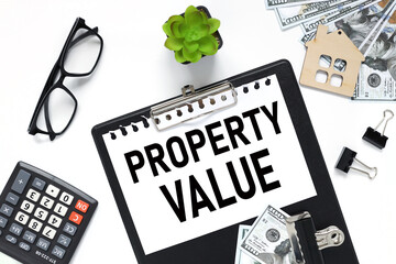 Property Value. black clipboard, with a white sheet of paper on a white background. black glasses. calculator. business concept