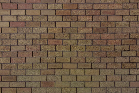 Small bricks red and broen color arranged in rows on the wall
