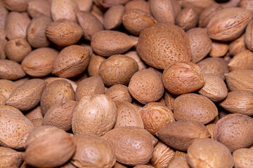 close up of almonds in the shell in the market