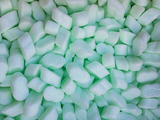 Polystyrene foam chips colored green used as infill material for packaging - 468958604