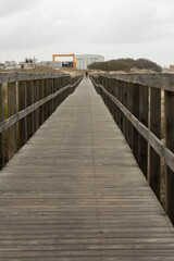 man standing at the end of a wooden path