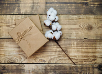 Boxes packed in kraft paper, twine on a wooden background.Environmentally friendly material.Christmas and New Year.