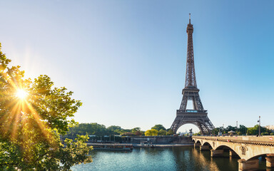 Obraz premium Paris street with view on the famous paris eiffel tower on a sunny day with some sunshine