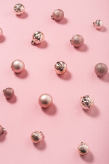 Obraz na płótnie Canvas Background with beautiful shiny pink decorative balls on a pink background. Top view, flat lay.