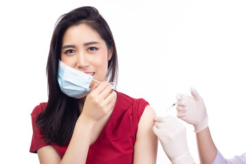 Young woman open medical face mask because get Covid-19 vaccine at doctor's office Professional nurse giving flu injection to patient Vaccination Immunization campaign and disease prevention concept