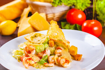 Caesar salad with shrimps on white plate