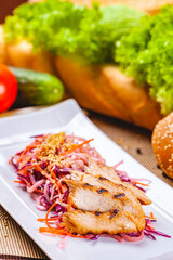 Salad with eel, carrot, red onion, sesame seeds on white plate