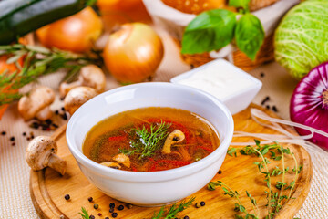 Vegetable soup with herbs and spices in white plate