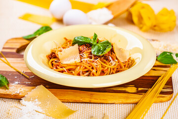 Spaghetti bolognese with minced meat and parmesan cheese in beige plate