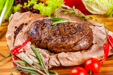 Grilled meat with spices and herbs  on wooden board