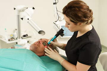 Middle aged man during laser treatment in a medical aesthetic clinic