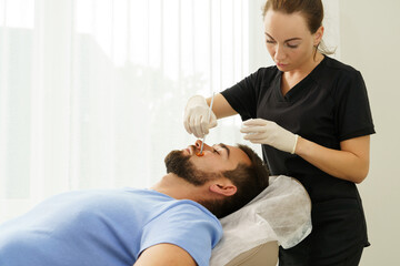 Fototapeta premium Young man during peeling treatment in beauty clinic