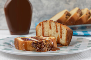 two slices of walnut bread with cajeta on a plate on a table