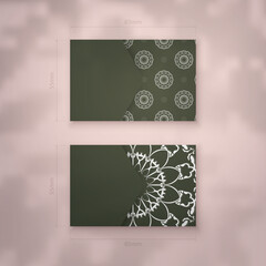 Business card template in dark green color with Greek white ornaments for your business.