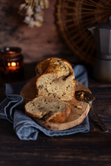 Fresh home made banana bread or butter sponge cake on rustic dark wooden table, organic country still life dessert image. Close up view with copy space. 