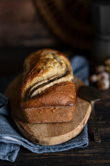 Fresh home made banana bread or butter sponge cake on rustic dark wooden table, organic country still life dessert image. Close up view with copy space. 