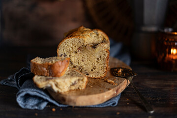 Fresh home made banana bread or butter sponge cake on rustic dark wooden table, organic country...