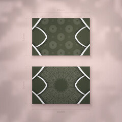 Business card template in dark green color with vintage white pattern for your business.