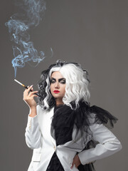 A fatal beauty in a daring fashion image with black and white hair. A rebellious stylish image for...