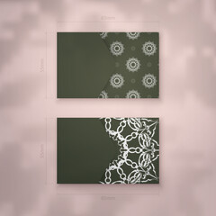 Business card template in dark green color with vintage white pattern for your business.