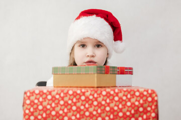 New Year's holiday. Portrait of a little girl with a Christmas style and gifts.