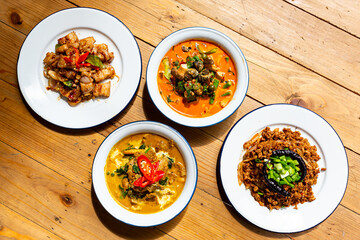 Top View Crispy Pork Belly with Chili and Salt and Curry with Beef Recipe and River snail red curry in red curry coconut milk soup and spicy minced pork salad (Larb Moo Kua). Thai food,
