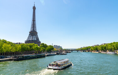 Paris street with view on the famous paris eiffel tower on a sunny day with some sunshine