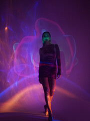 Obraz premium Glamorous portrait of a young beautiful blonde in a stylish scarlet short dress, stylish shooting with smoke and a laser projector.