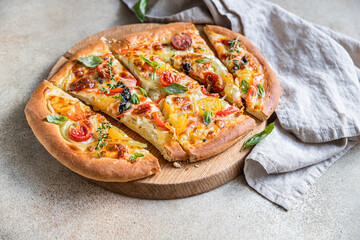 Pinsa with vegetables and cheese, concrete background. Traditional rome pizza.
