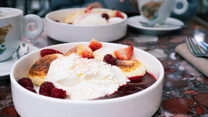 Delicious appetizing beautiful dish of syrniki. Meeting at the cafe.