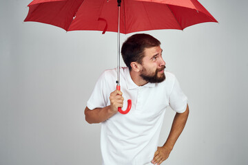 Cheerful man and red umbrella protection lifestyle