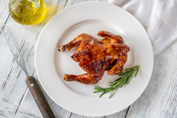 Roasted chicken on the white plate