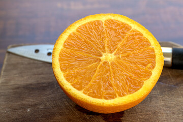 Sweet Chilean orange, cut on a wooden board