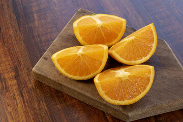 Sweet Chilean orange, cut on a wooden board