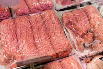Various packages of beef or pork minced meat in the supermarket